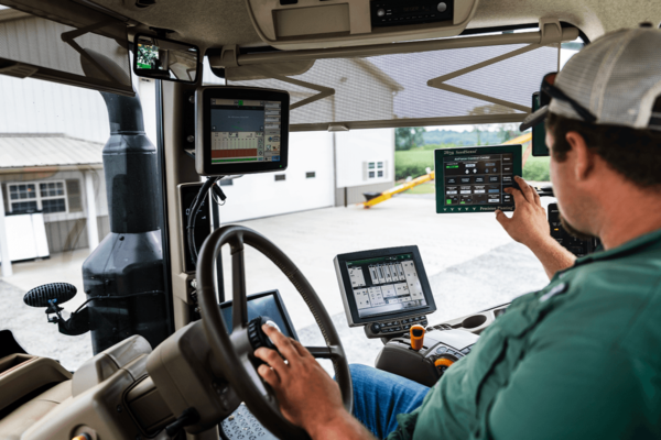 A farmer uses the monitors inside of his tractor cab.
