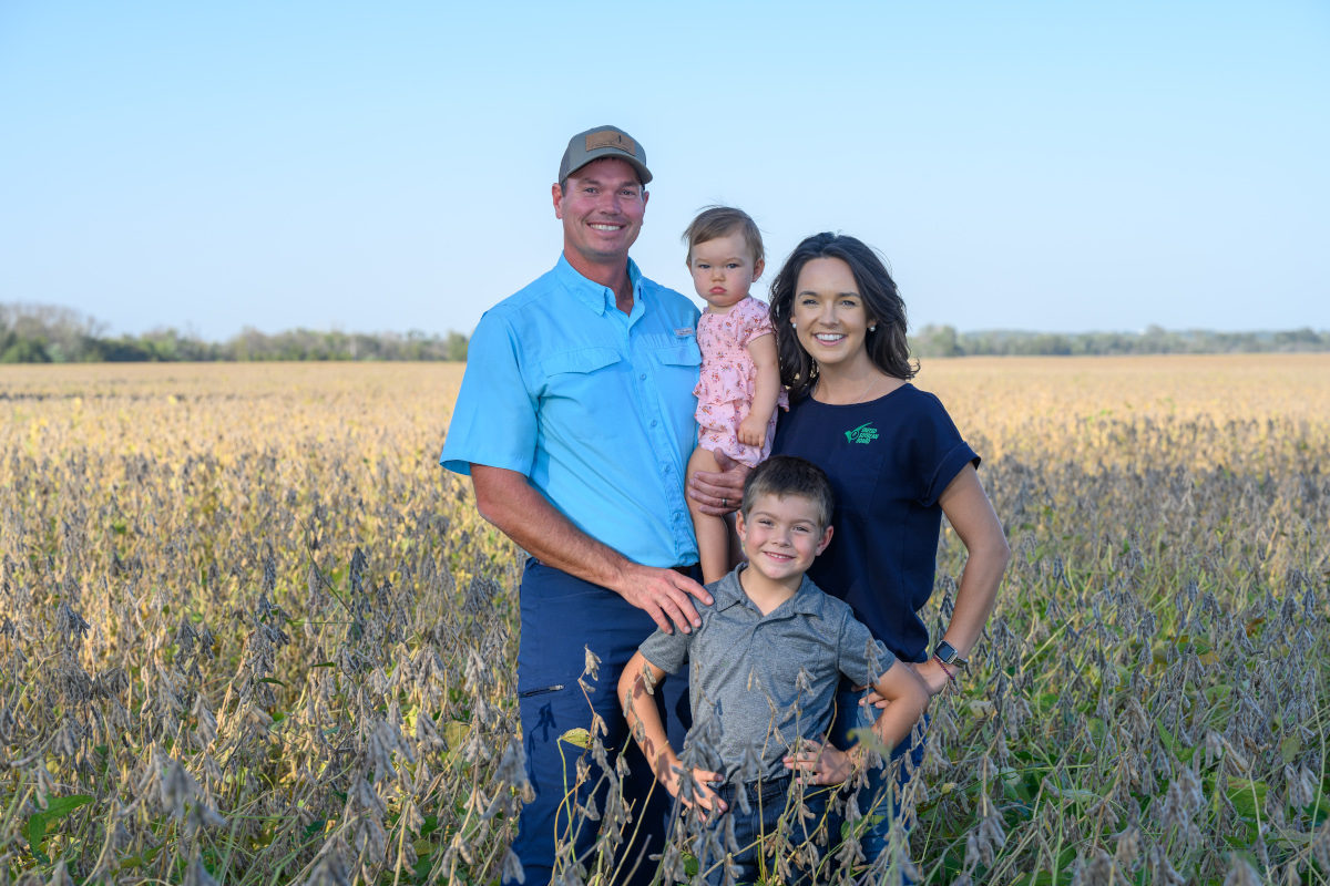 Meagan Kaiser and her family stand to pose in a soy field.