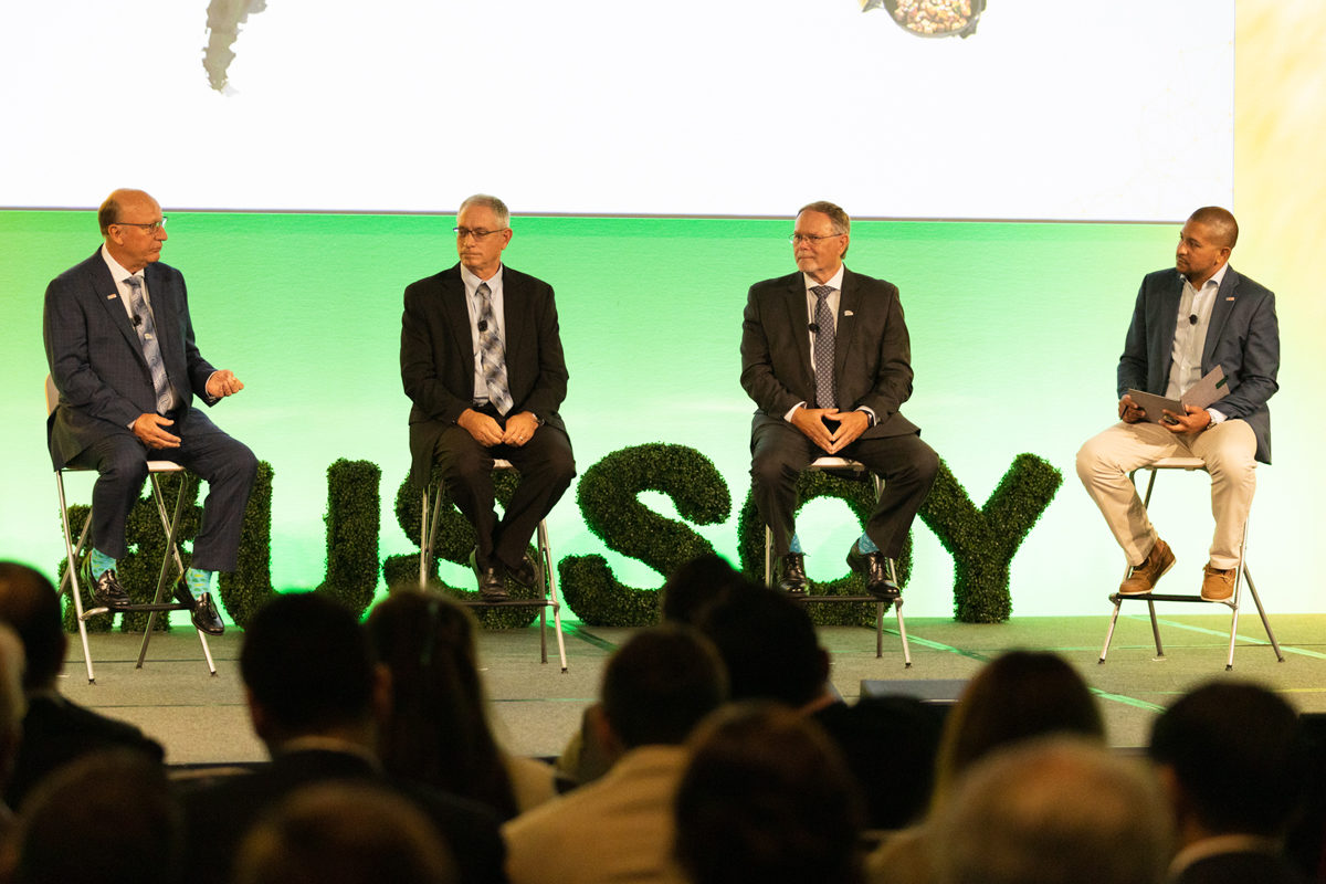 Doug Winter, Lance Rezac, Monte Peterson, and Mac Marshall sit on stage at the Soy Connext event.